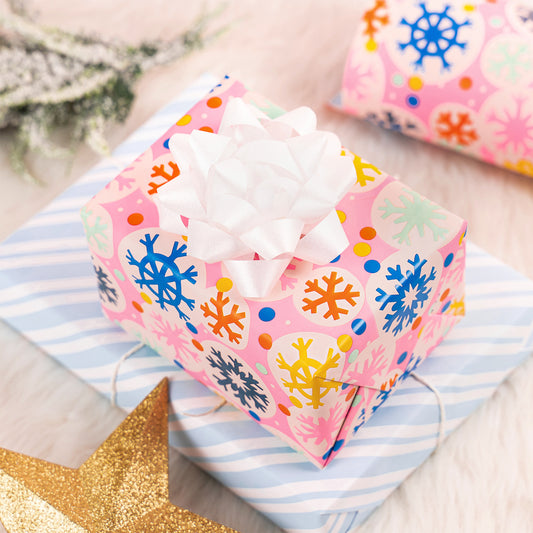 Pink Snowflake Wrapping Paper Roll with Blue and White Diagonal Stripes on The Back Wholesale Wrapholic
